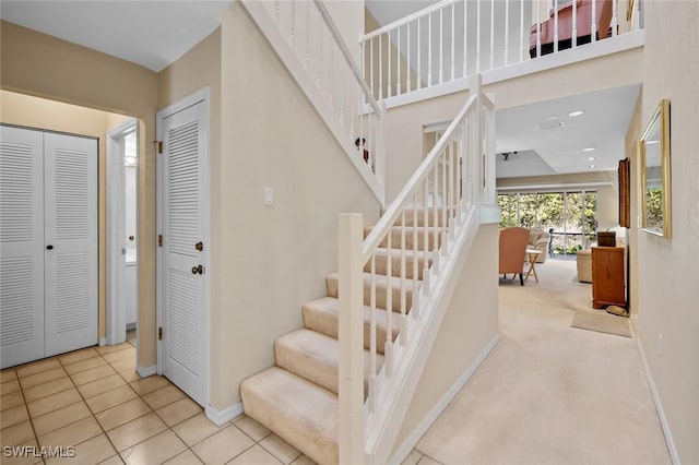 stairs featuring tile patterned flooring