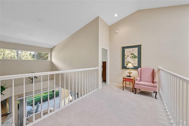 living area featuring light carpet and lofted ceiling