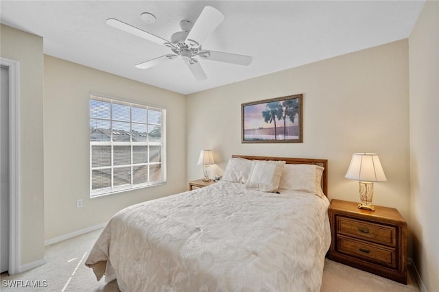 bedroom with ceiling fan and light colored carpet