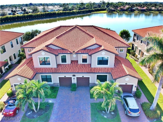 view of front of property with a water view and a garage