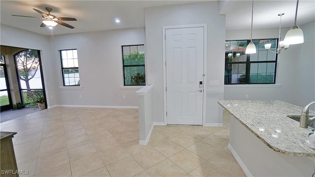 interior space featuring ceiling fan and light tile patterned floors