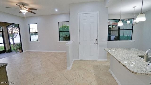 foyer with ceiling fan, baseboards, light tile patterned flooring, and recessed lighting