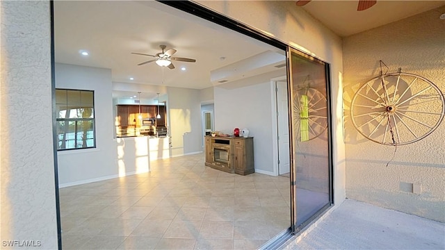 corridor featuring baseboards, recessed lighting, and light tile patterned floors