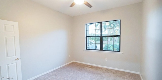 unfurnished room featuring baseboards, a ceiling fan, and carpet