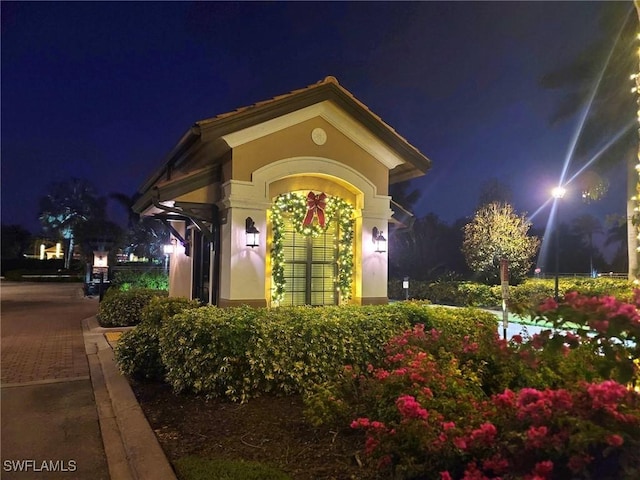 view of exterior entry at twilight