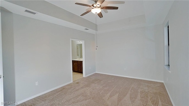 unfurnished room featuring visible vents, light carpet, baseboards, and ceiling fan
