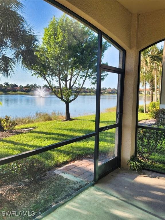 unfurnished sunroom featuring a water view