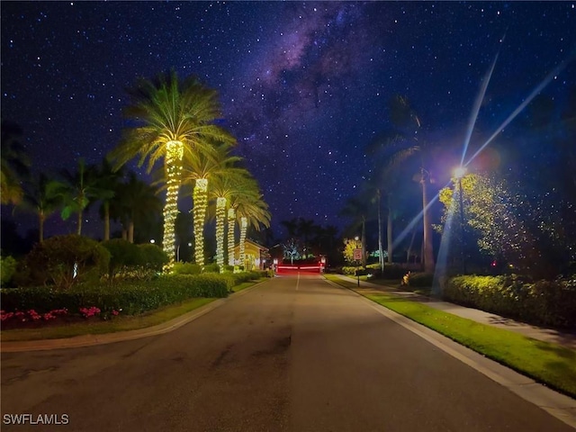 26217 Palace Ln Unit 102, Bonita Springs, FL 34135 - view of asphalt road featuring curbs and sidewalks