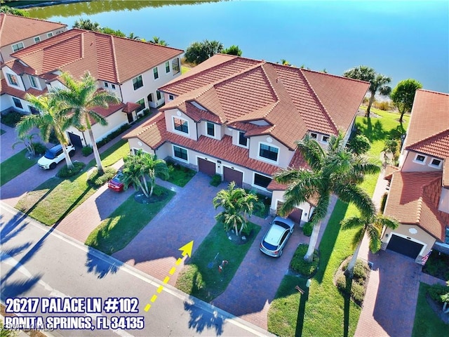 birds eye view of property featuring a water view and a residential view