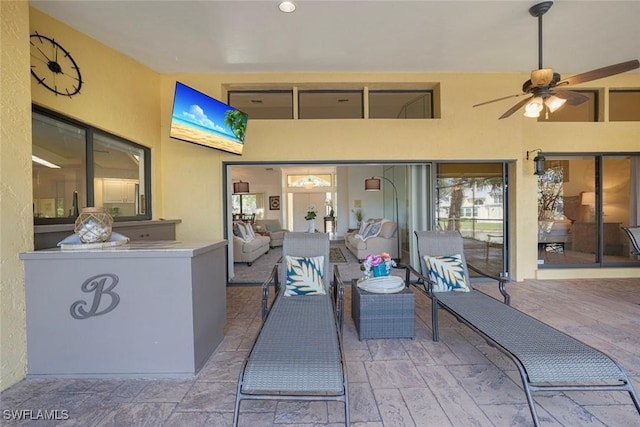 view of patio featuring outdoor lounge area and ceiling fan