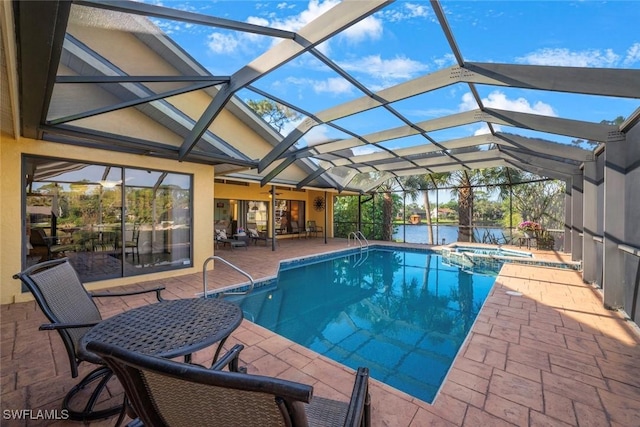 view of swimming pool featuring glass enclosure, an in ground hot tub, a patio area, and a water view