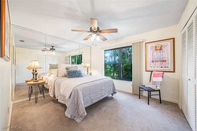 carpeted bedroom with a closet and ceiling fan