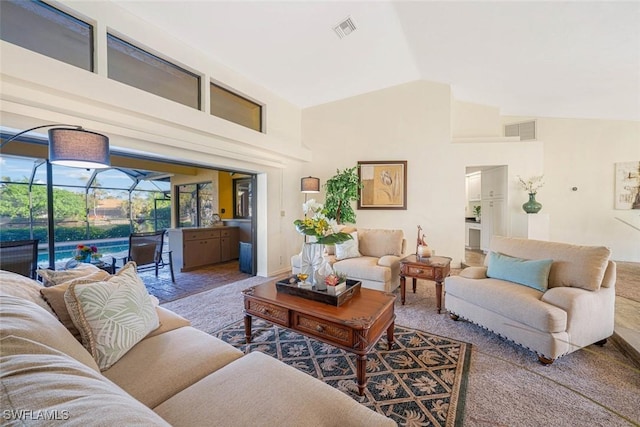 living room with high vaulted ceiling