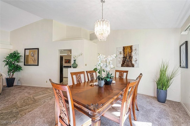 dining room featuring a chandelier, light colored carpet, and vaulted ceiling