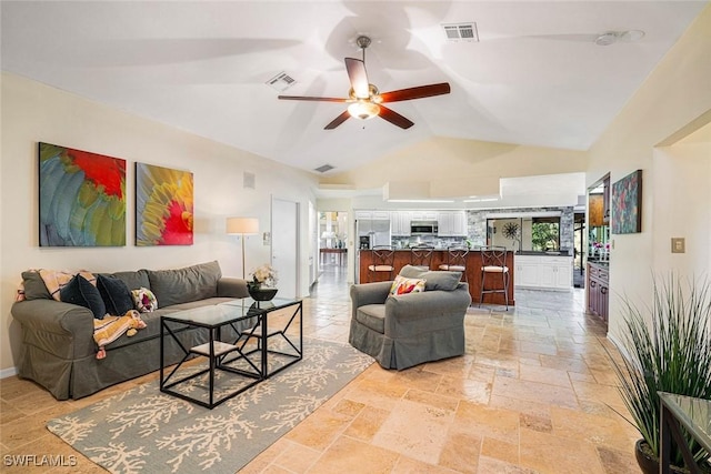 living room featuring vaulted ceiling and ceiling fan