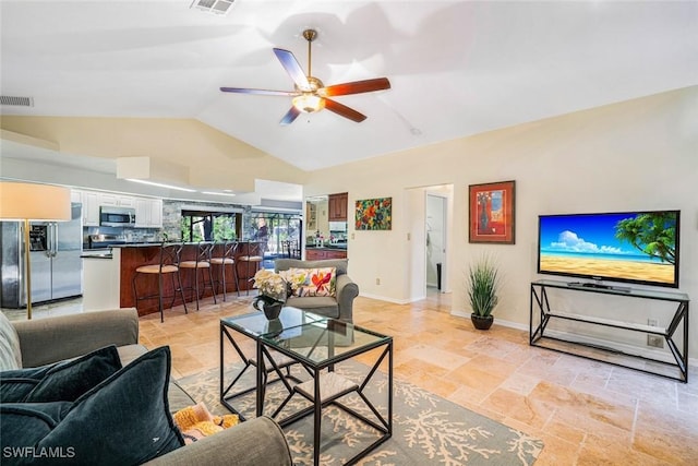 living room with ceiling fan and lofted ceiling