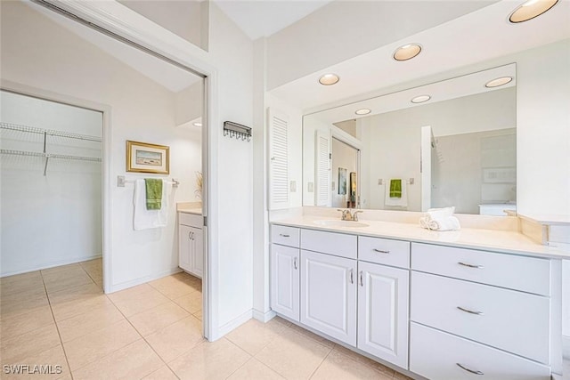 bathroom featuring tile patterned floors, vanity, and lofted ceiling