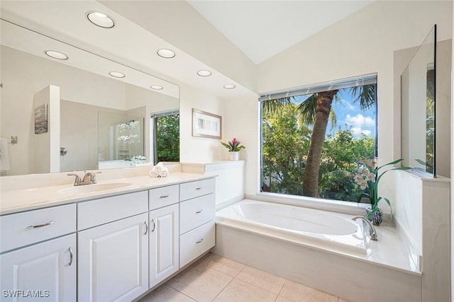 bathroom featuring tile patterned flooring, vanity, lofted ceiling, and plus walk in shower