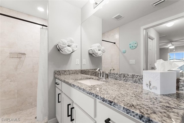 bathroom with a shower with curtain, ceiling fan, and vanity