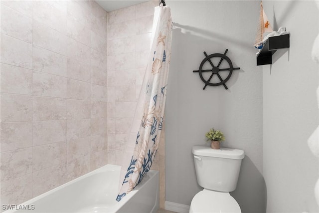 bathroom featuring shower / bath combination with curtain and toilet