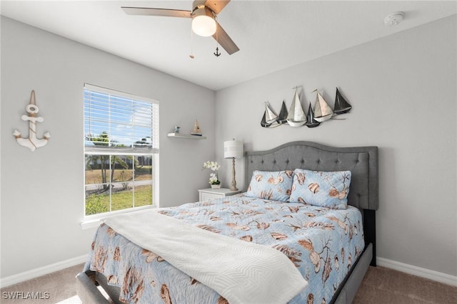 carpeted bedroom featuring ceiling fan and multiple windows