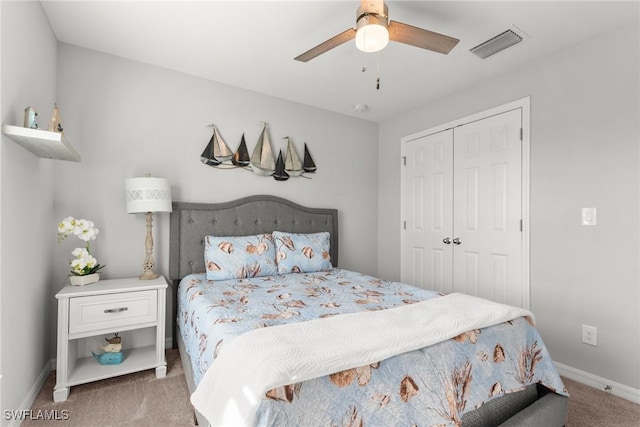 carpeted bedroom featuring ceiling fan and a closet