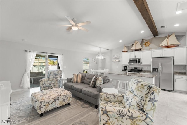 tiled living room with vaulted ceiling with beams, ceiling fan, and sink