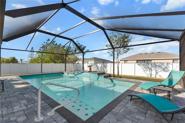 view of swimming pool featuring a patio and glass enclosure