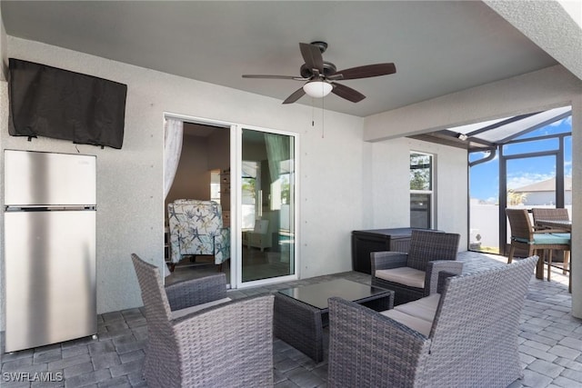 view of patio / terrace featuring a lanai and ceiling fan