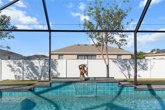 view of pool with glass enclosure