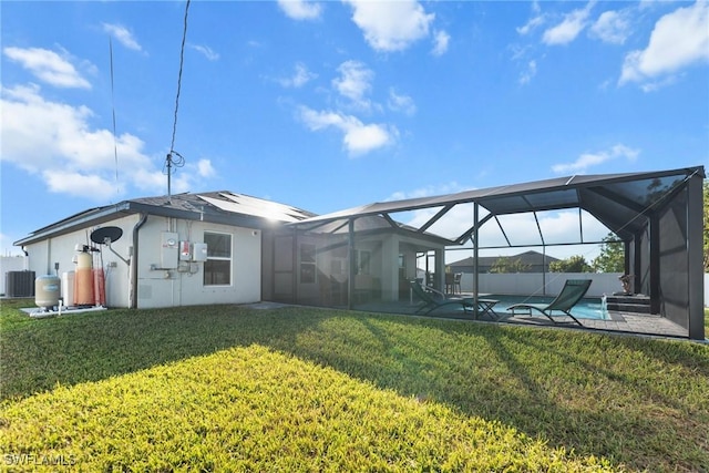 rear view of house featuring a lawn, cooling unit, a lanai, and a swimming pool