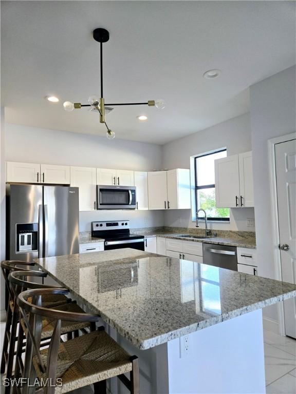 kitchen with a center island, sink, and appliances with stainless steel finishes