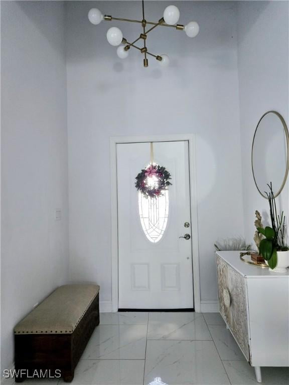 foyer with marble finish floor and baseboards