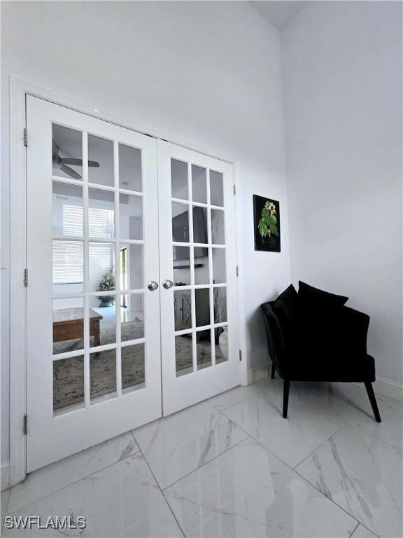 doorway to outside with marble finish floor, french doors, and baseboards