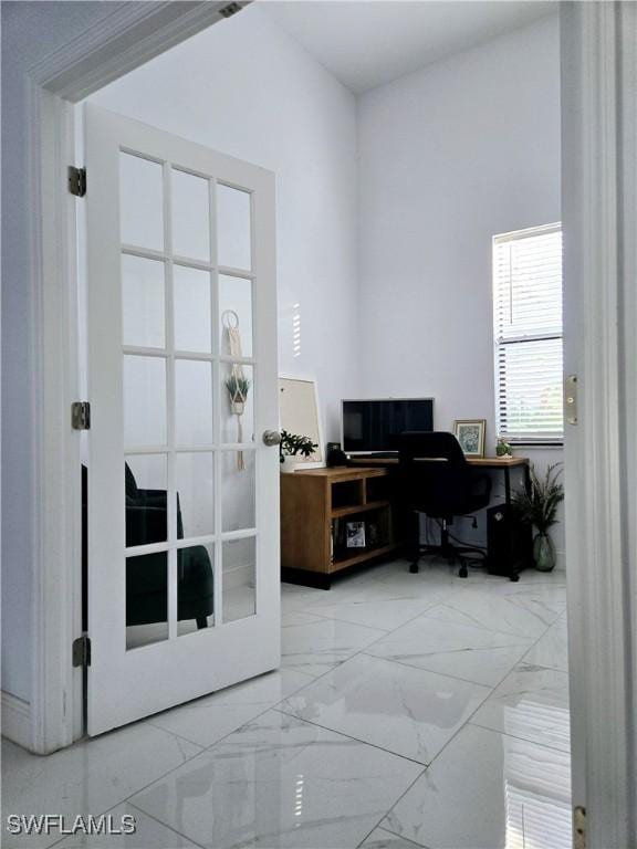 office featuring marble finish floor and french doors