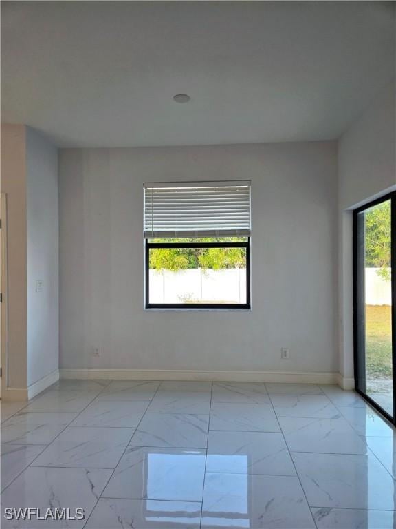 unfurnished room featuring a wealth of natural light