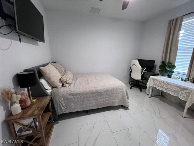 bedroom with marble finish floor, visible vents, and ceiling fan