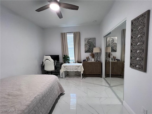 bedroom with marble finish floor and a ceiling fan