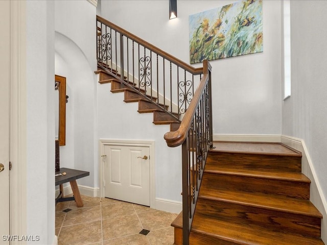 stairway featuring tile patterned flooring