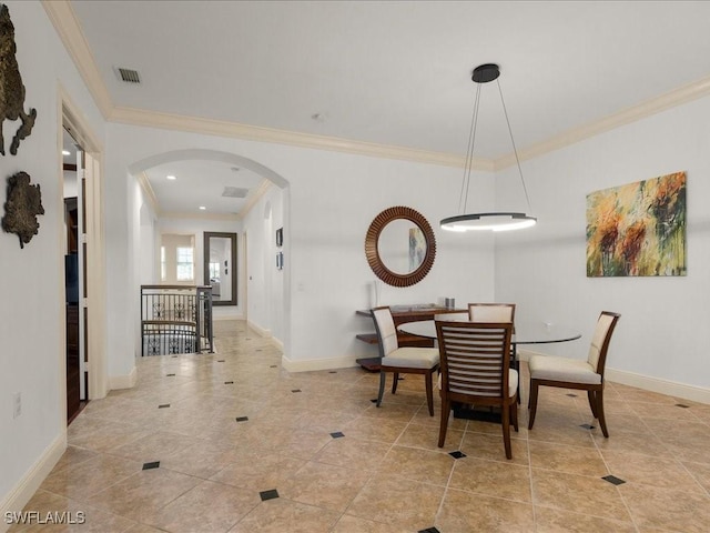 dining area featuring light tile patterned floors and crown molding