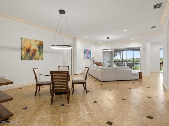 tiled dining area featuring ornamental molding