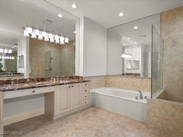 bathroom featuring tile patterned flooring, vanity, and separate shower and tub