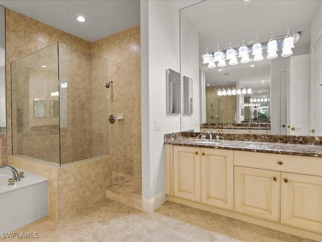 bathroom with tile patterned flooring, vanity, and shower with separate bathtub