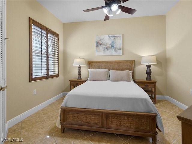 bedroom with ceiling fan and light tile patterned flooring