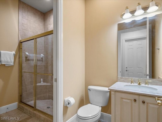 bathroom with toilet, vanity, tile patterned floors, and walk in shower