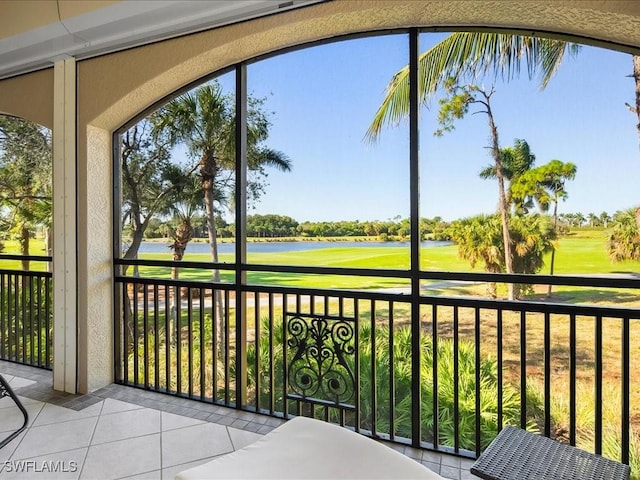 unfurnished sunroom with a water view