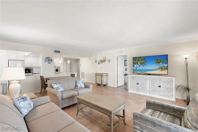 living room featuring light tile patterned floors and ornamental molding