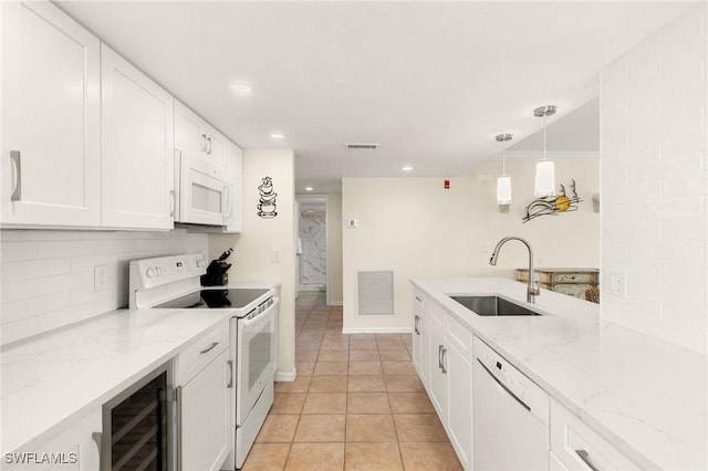 kitchen with white cabinets, white appliances, sink, and beverage cooler