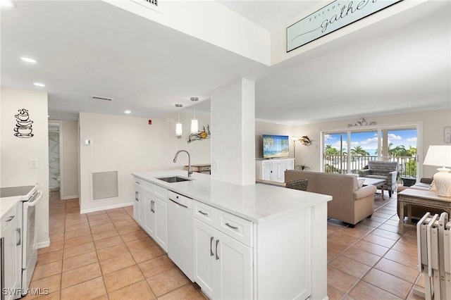 kitchen featuring white cabinetry, sink, light stone counters, pendant lighting, and white appliances