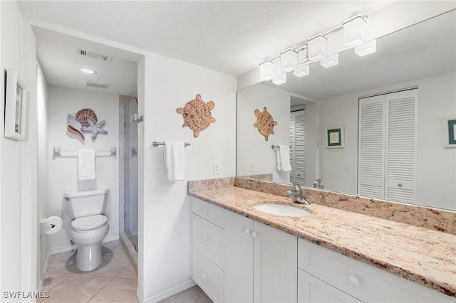 bathroom featuring tile patterned floors, vanity, toilet, and a shower with door